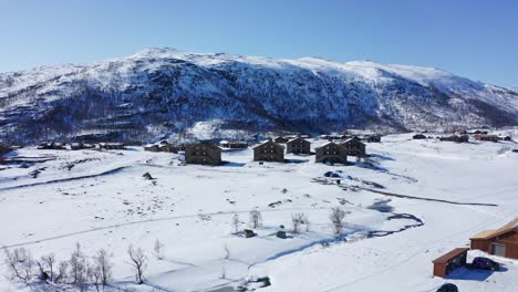 sideways moving aerial overview of lodging apartments with ski-in at hardangervidda mountain - maurset