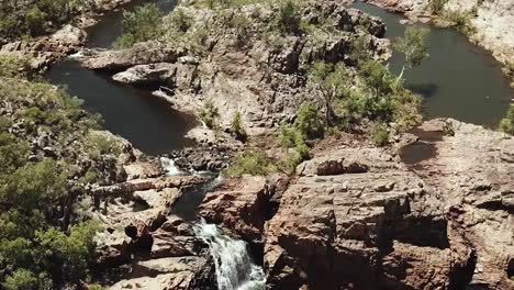 drone footage over large waterfall in australian bush land