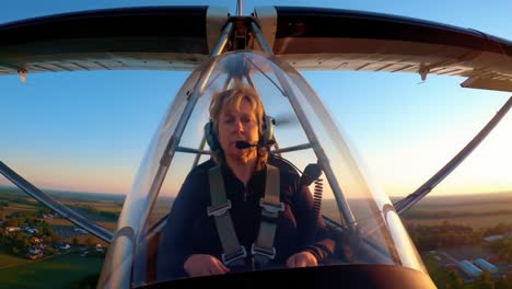 woman pilot in cockpit at sunrise/sunset