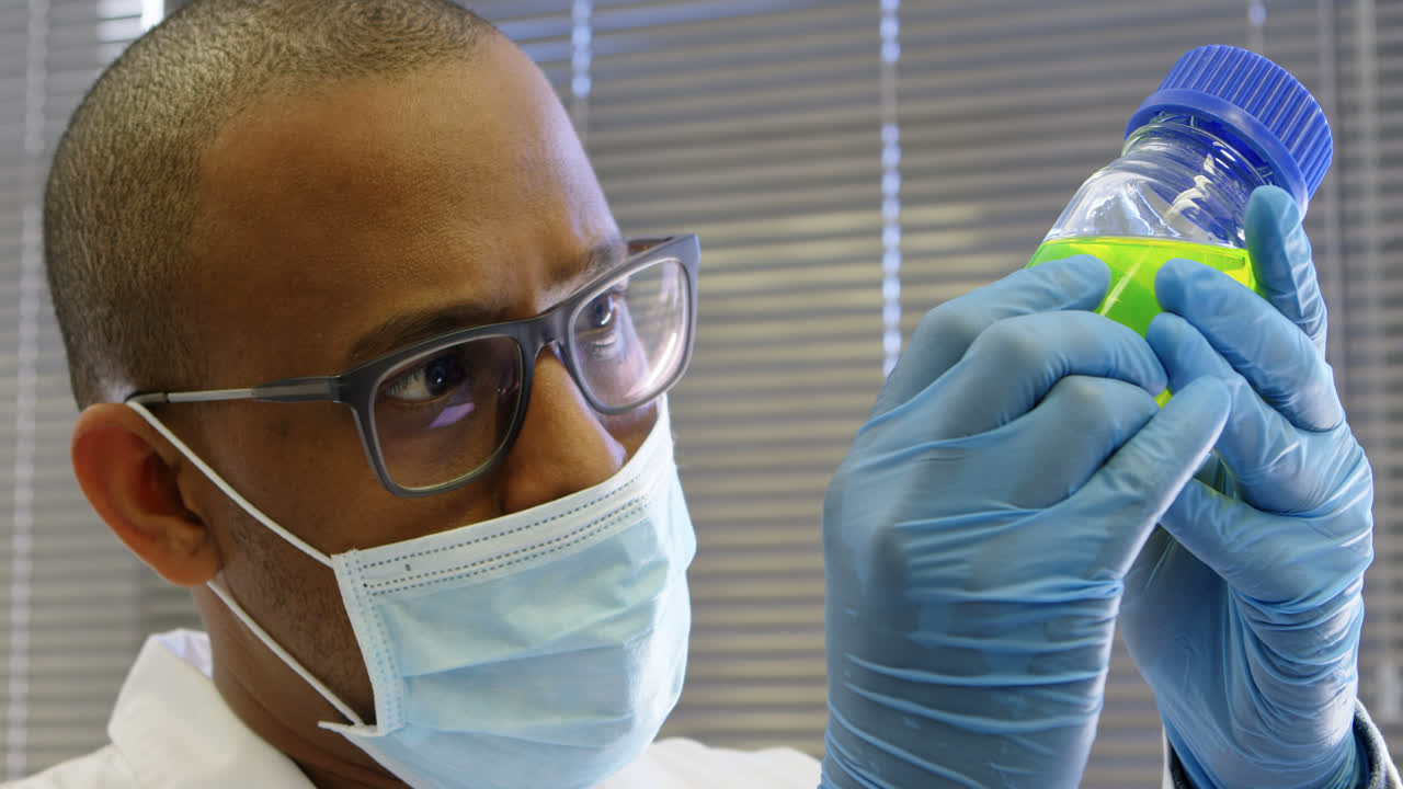 Scientist examining chemical solution 4k
