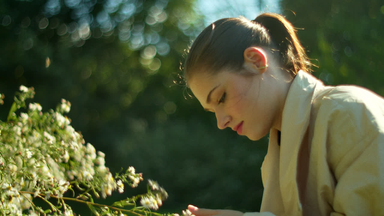 Woman enjoying flowers in a park