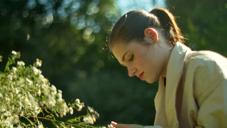 woman enjoying flowers in a park