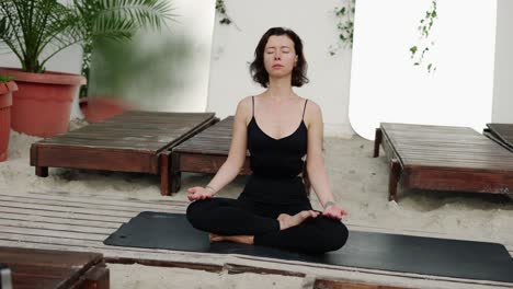 healthy woman doing yoga asana meditation on the beach