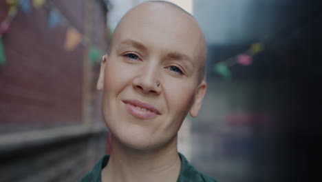 woman with bald head smiling in urban setting