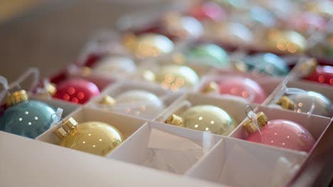 detailed shot of vibrant, shiny christmas ornaments arranged in a box