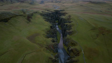 Aerial-View-Of-A-River-Flowing-In-Fjadrargljufur-Canyon,-South-East-Iceland