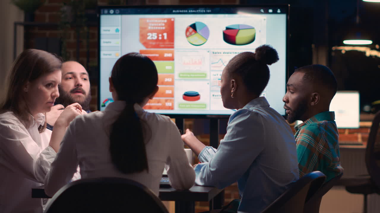 Diverse coworkers brainstorming in business meeting, discussing analytics presentation