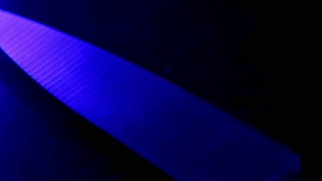 kitchen knife iluminated by red and blue police lights, psycopath killer crime concept metaphor video