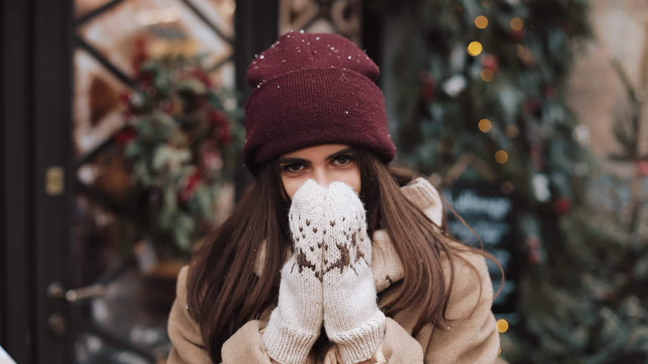 Woman in winter clothing with Christmas decorations
