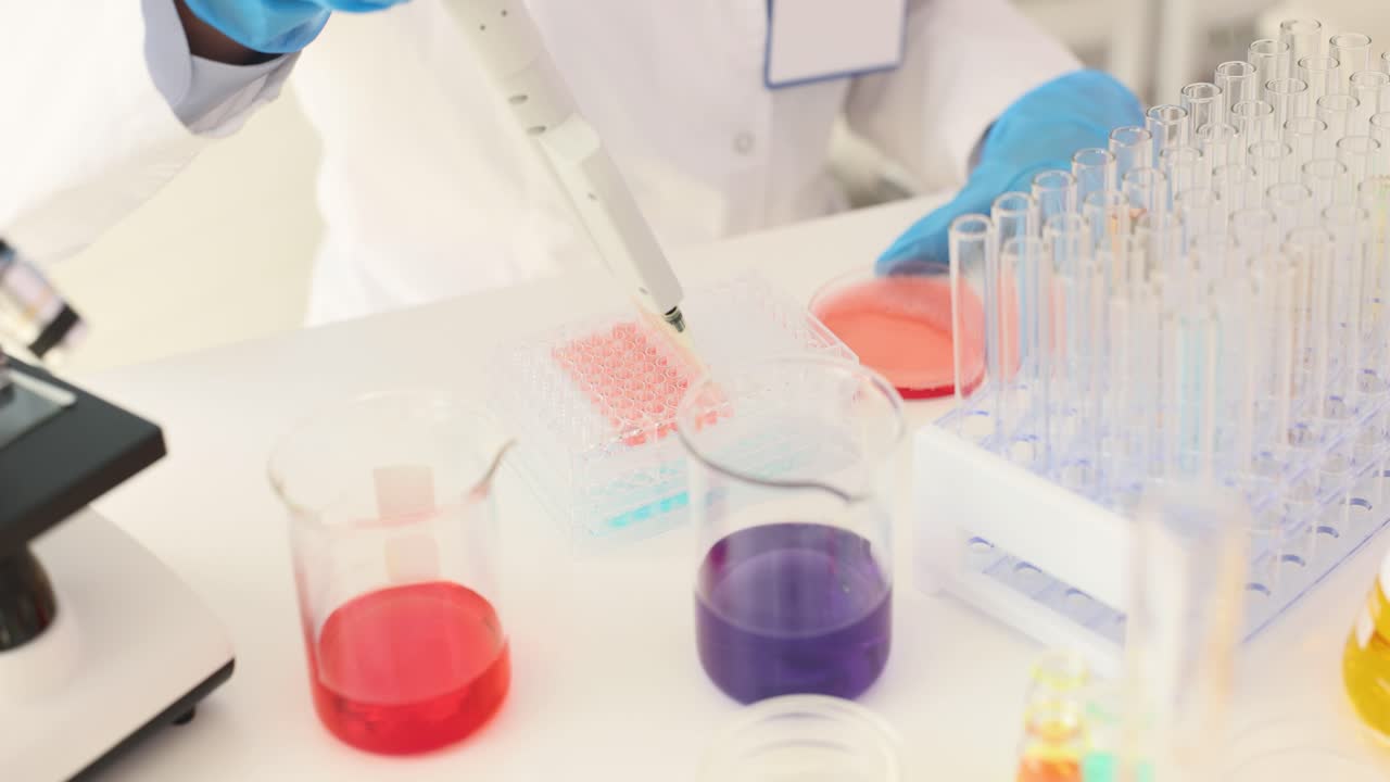 Scientist performing laboratory experiment with liquids and equipment