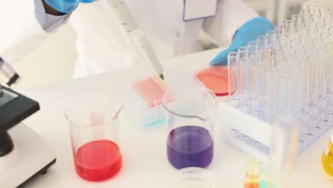 scientist performing laboratory experiment with liquids and equipment