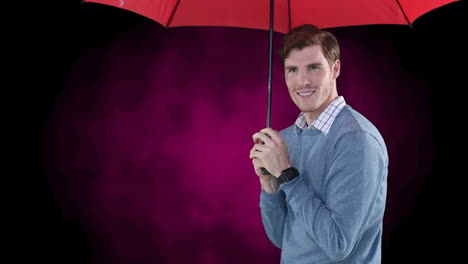 hombre sonriente poniendo un paraguas rojo y refugiándose debajo de él, sobre un fondo rosa y negro