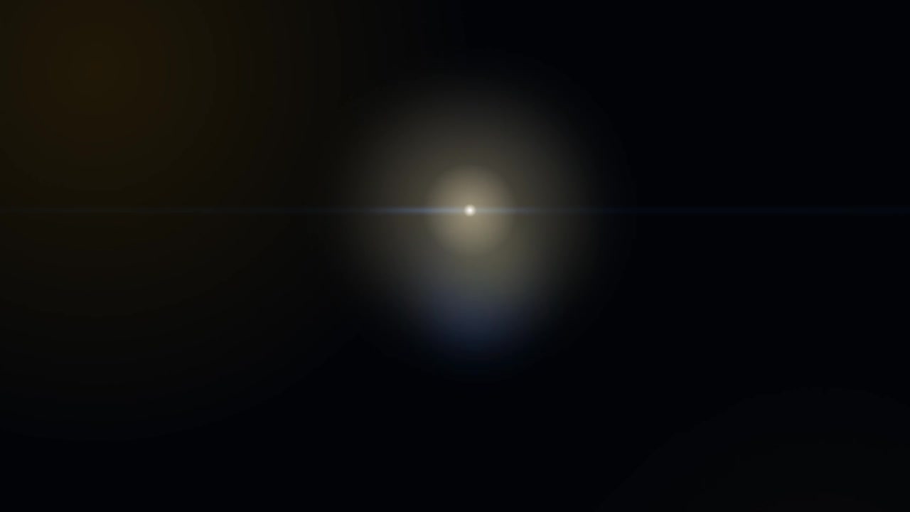 Abstract Lens Flare Moving Across Dark Background