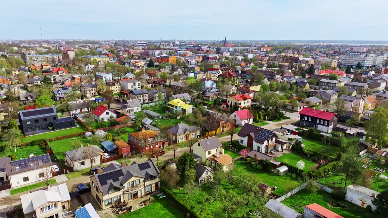 Drone glides forward above Liepaja’s green suburb on a bright spring morning day