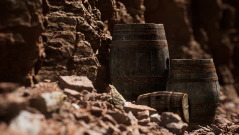 old wooden vintage wine barrels near stone wall in canyon