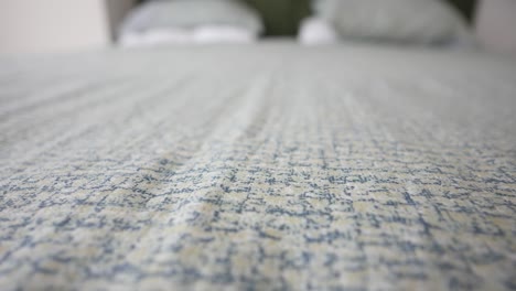 close-up of a bedsheet with a subtle pattern