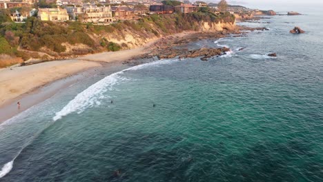 Flying-over-million-dollar-beach-front-luxury-homes-and-the-beautiful-Laguna-Beach-California-tide-pools-at-Sunset-in-stunning-4k-resolution