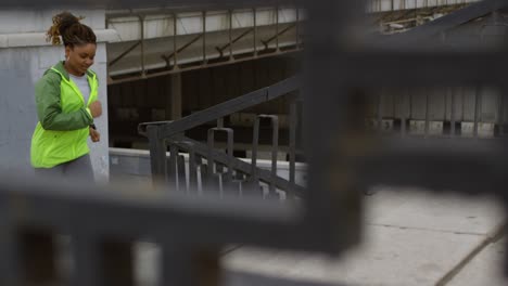 woman in sportswear running and climbing stairs with friend