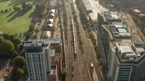 aerial shot following a train leaving reading town