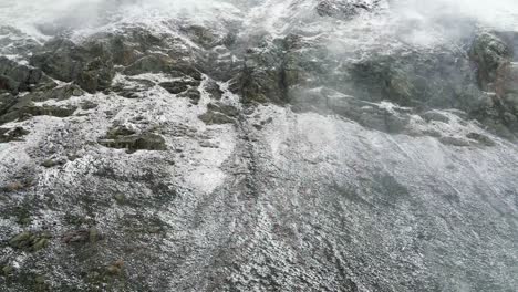 4k aerial drone footage of mist and clouds over snowy rocky mountains near breckenridge colorado in winter