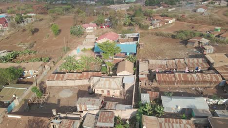 drone shot flying over huts and buildings in a small and remote african village