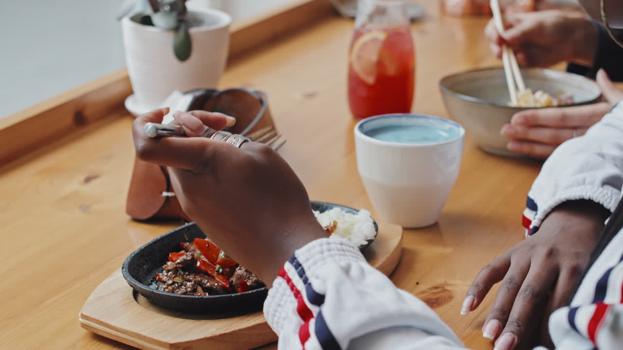 Black Woman Enjoying Food in Cafe