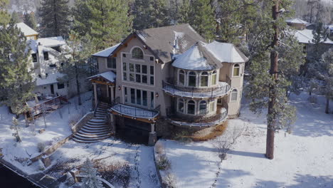 warm christmas welcome home winter big bear california aerial, snow covered mansion surrounded by trees