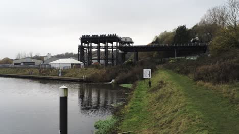 Industrial-Victorian-Anderton-canal-boat-lift-Aerial-view-River-Weaver-moving-forward-over-canal