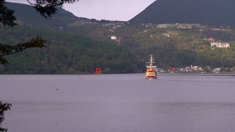 view out towards hakone shrine and famous pirate ship on lake ashi in japan