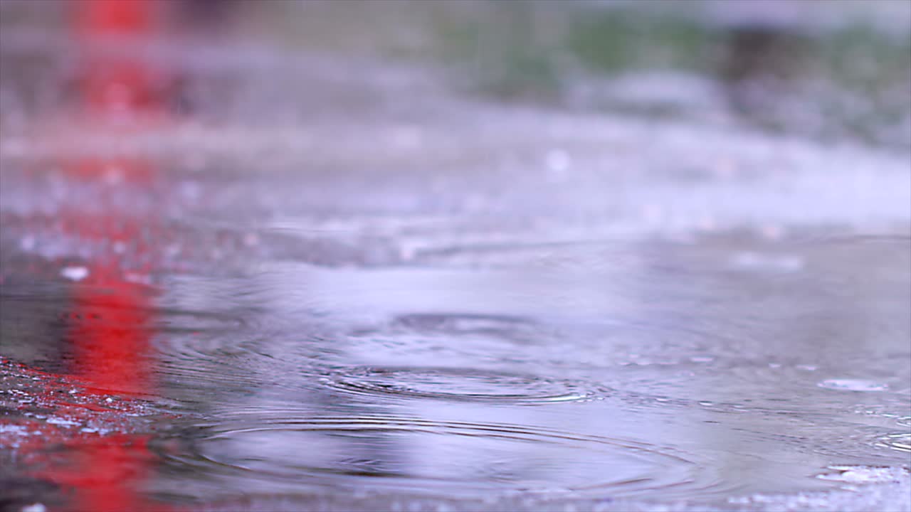 Rain Drops Falling To Asphalt