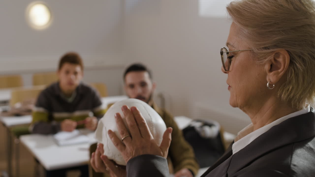 Teacher Explaining Anatomy with Skull Model