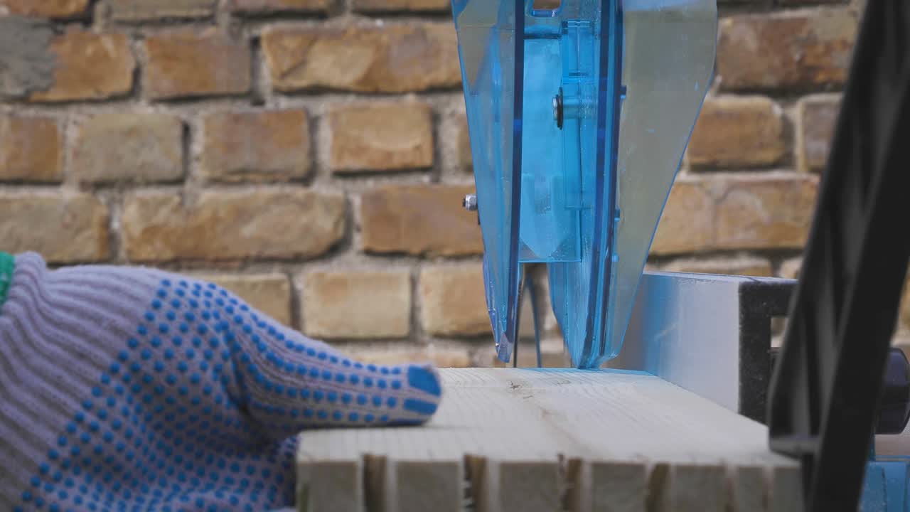 Handy man cutting wood on a table saw. Carpentry wood work.