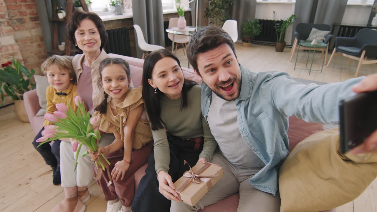 A family taking a selfie together indoors
