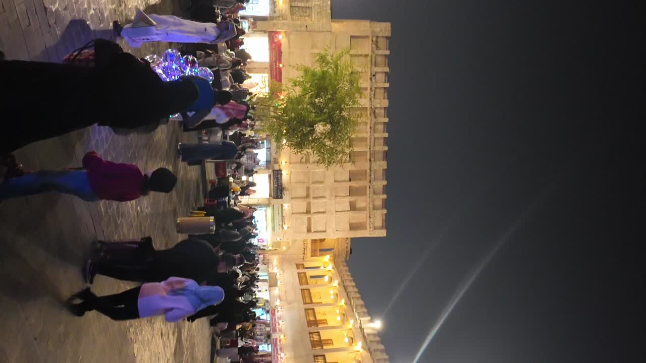 Nighttime urban scene with people near architecture