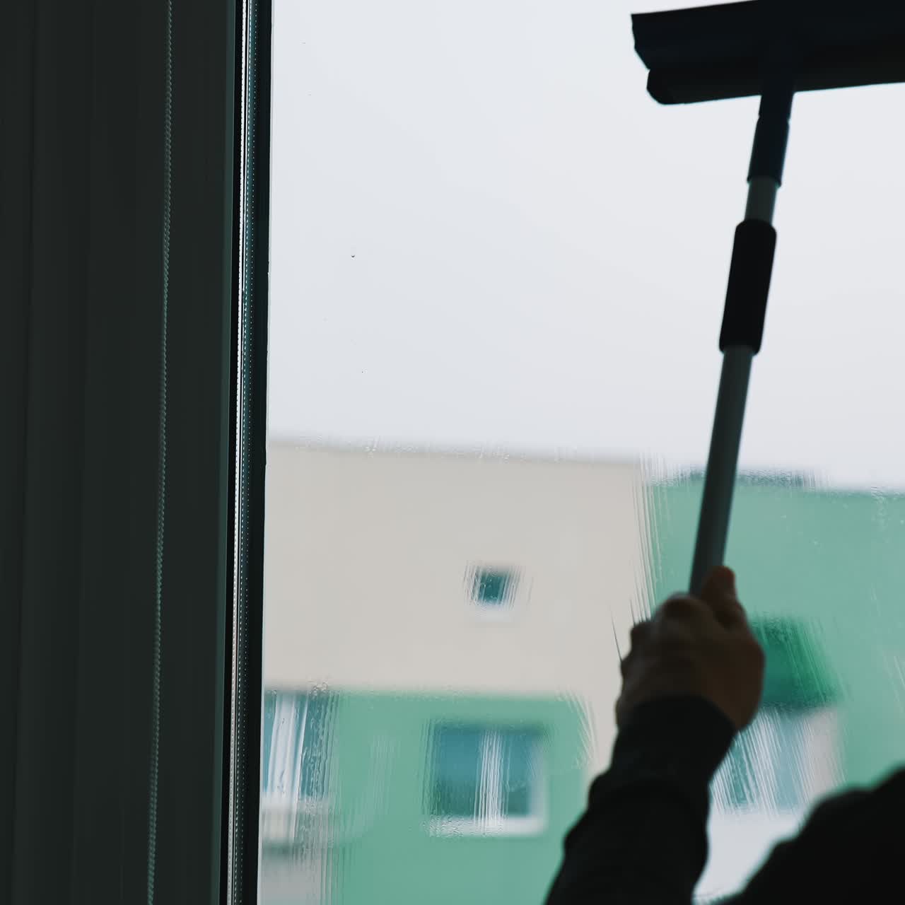 Window water cleaning with professional devices. Wet glass cleaning