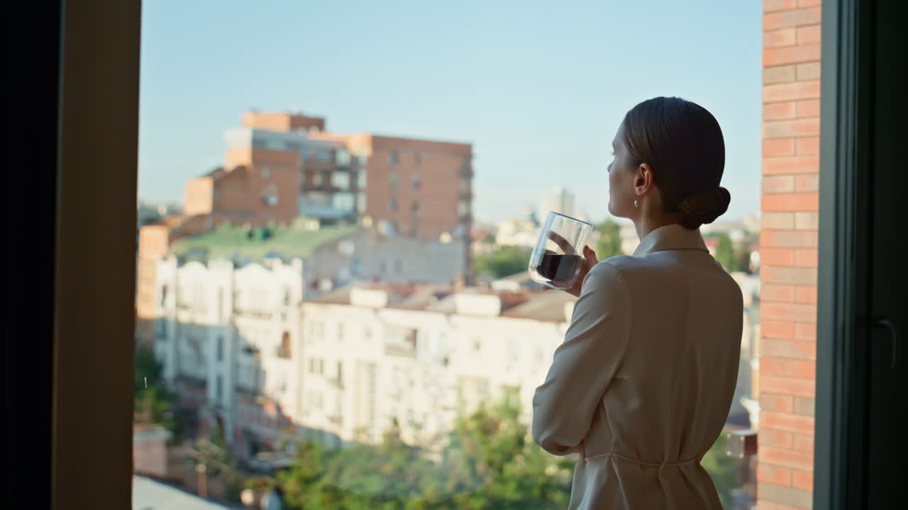 Business lady sipping coffee looking on city view from panoramic window closeup
