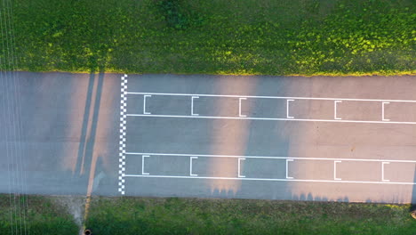 overhead view of a karting track finish line with two karts finishing