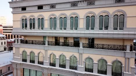 ornate building facade with balconies and snow