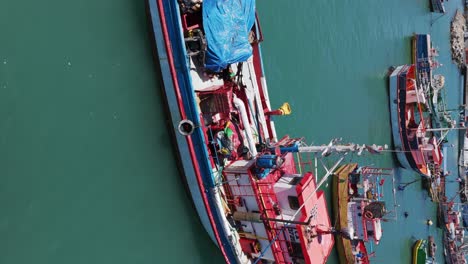 aerial flying over moored fishing boats in port of san antonio in chile