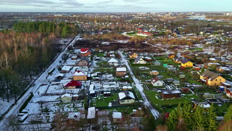 sunlight melting snow in a village in latvia while in the shadow everything is covered in snow