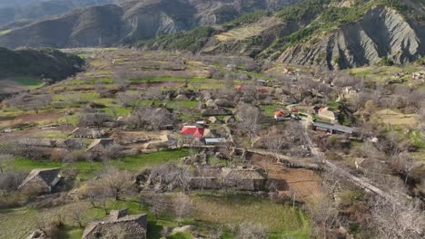 Small-village-on-mountain-slope-with-stone-tiles-on-rooftops