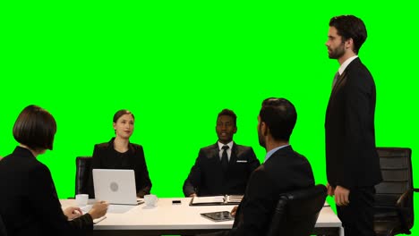 businessman touching invisible screen during meeting