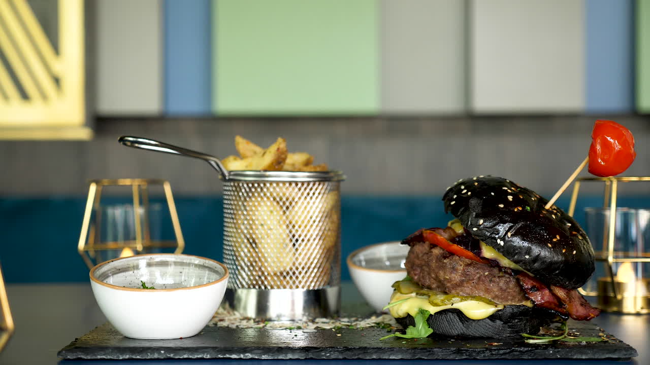 Black burger with fries