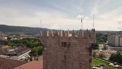 aerial parallax of medieval tower of chaves castle, cityscape as background