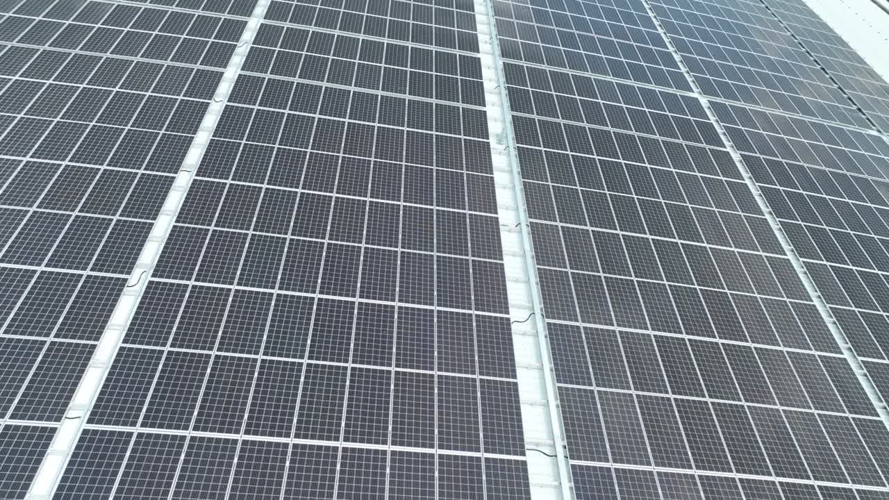 Closeup of surface of blue photovoltaic solar panels mounted on building roof for producing clean ecological electricity. Production of renewable energy concept