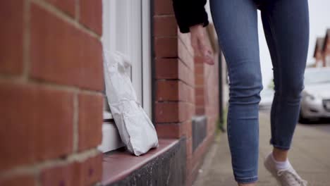 girl safely dropping off a care package to grandparent's house | close-up shot