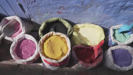 Bright,-Vibrant---Colourful-Powder-Pigments-in-the-Traditional-Streets-of-Chefchaouen,-Morocco