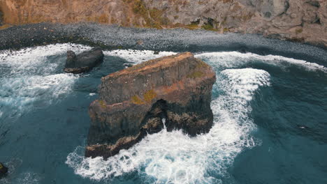 fantastic aerial shot in orbit close to a rock formation located on los roques beach on the island of tenerife on a sunny day