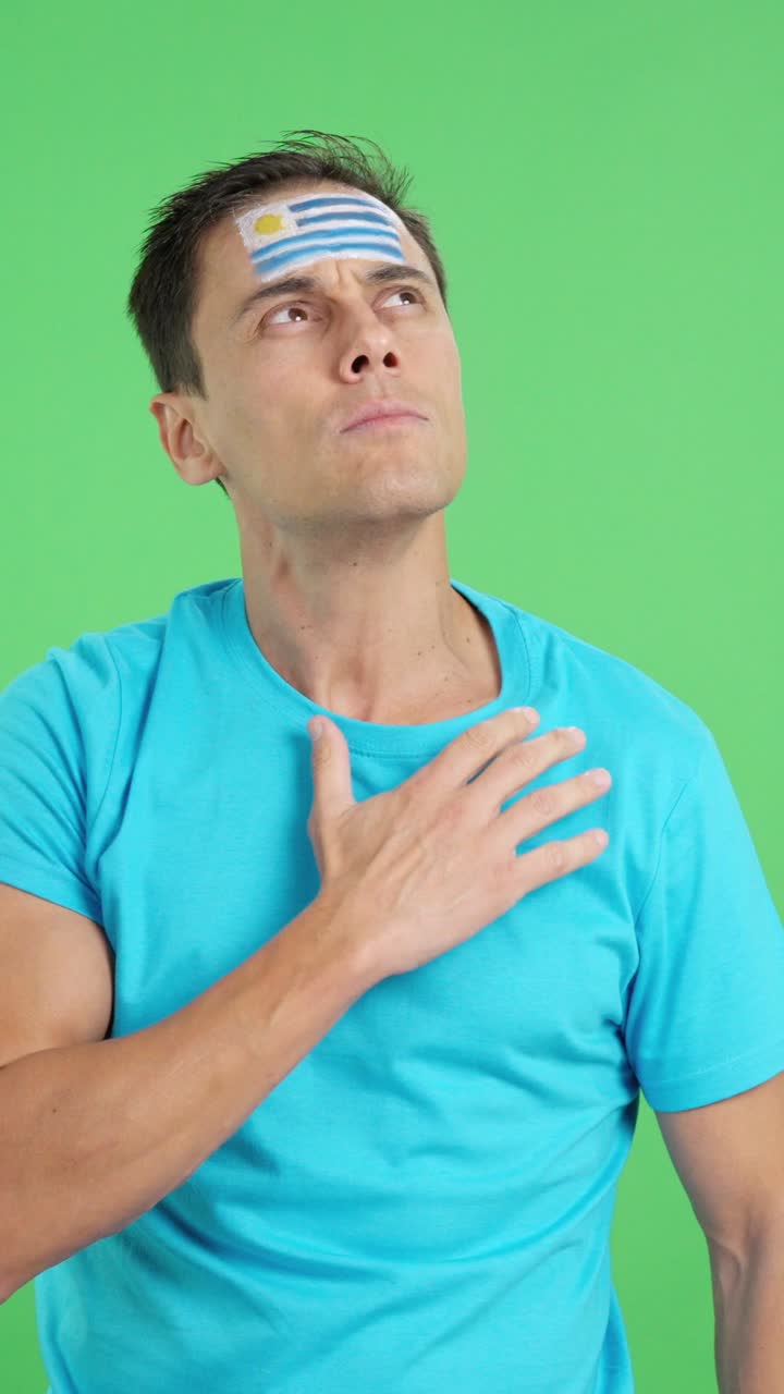 Man listening to the Uruguay national anthem with solemnity