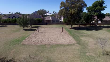 drone footage of scottsdale city park, pull back from volleyball court